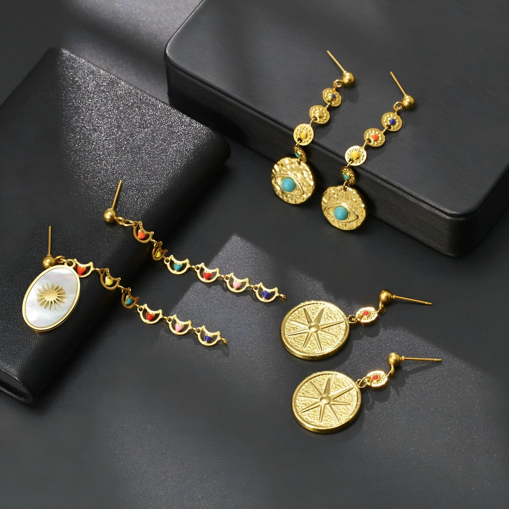 Geometric stainless steel earrings showing eight-awl-star, eye and shell-sun design variations