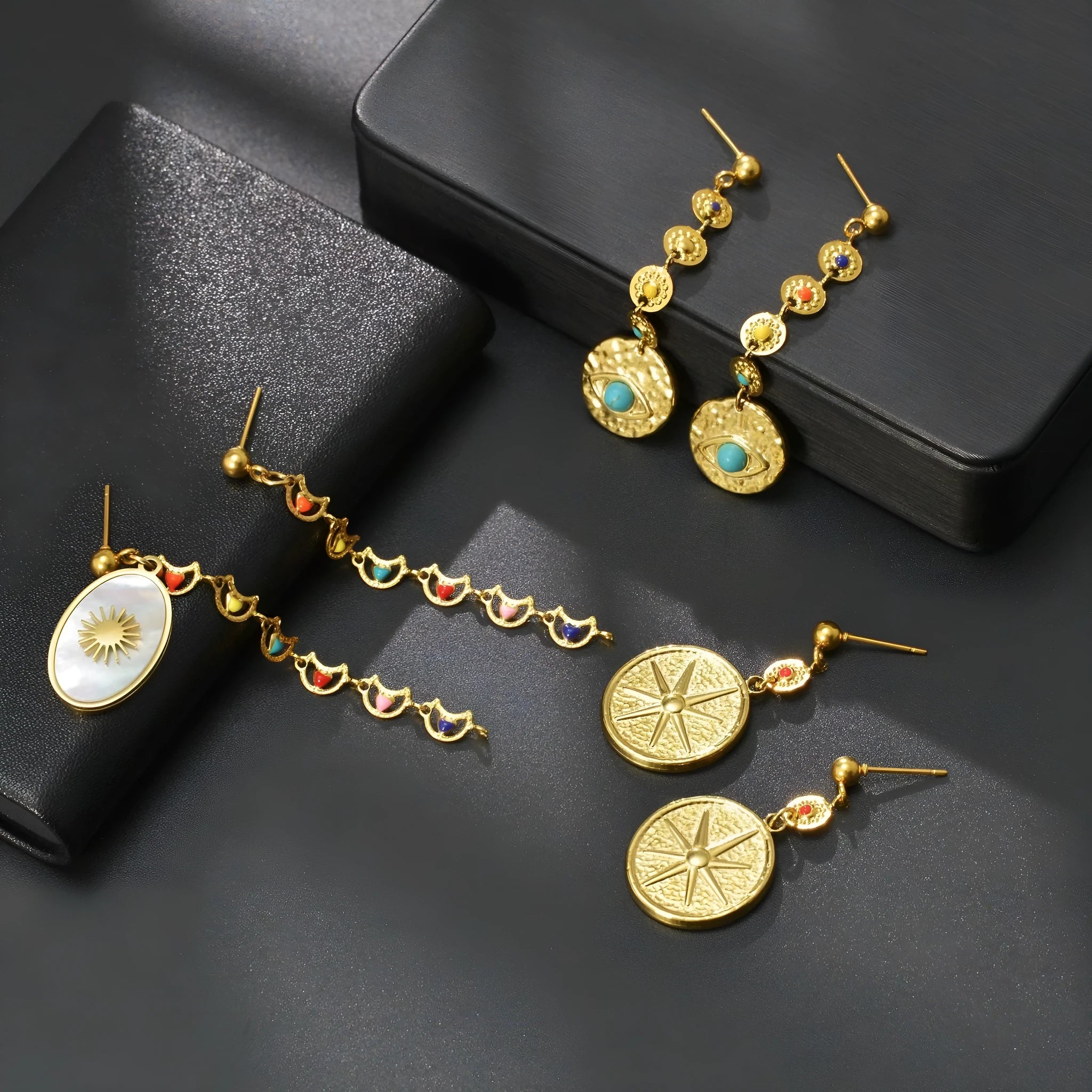 Geometric stainless steel earrings showing eight-awl-star, eye and shell-sun design variations