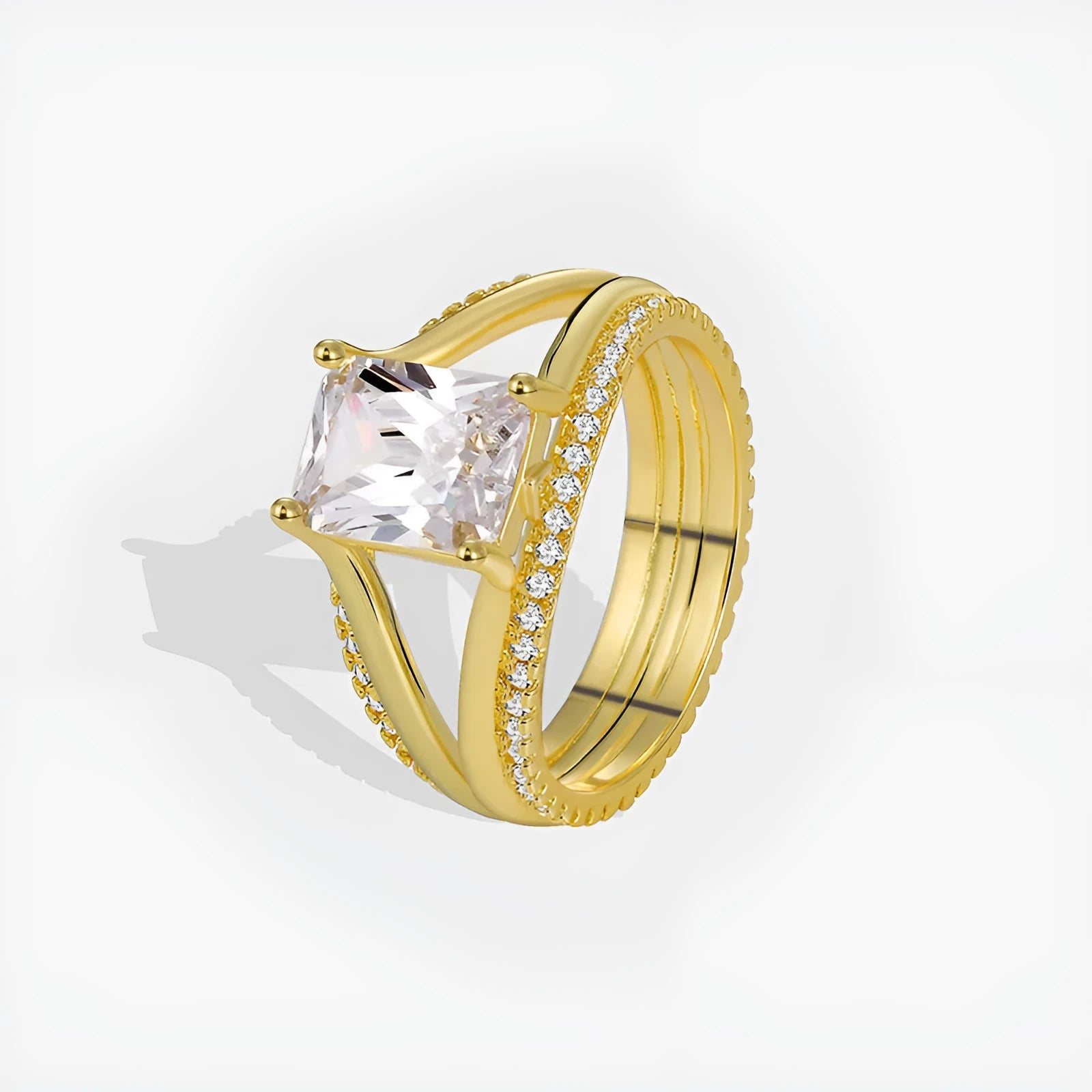 Gold geometric women's ring with a square zircon stone on a hand.