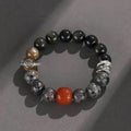 Gold obsidian flame stone and red agate unisex bracelet with original Wukong design on neutral background