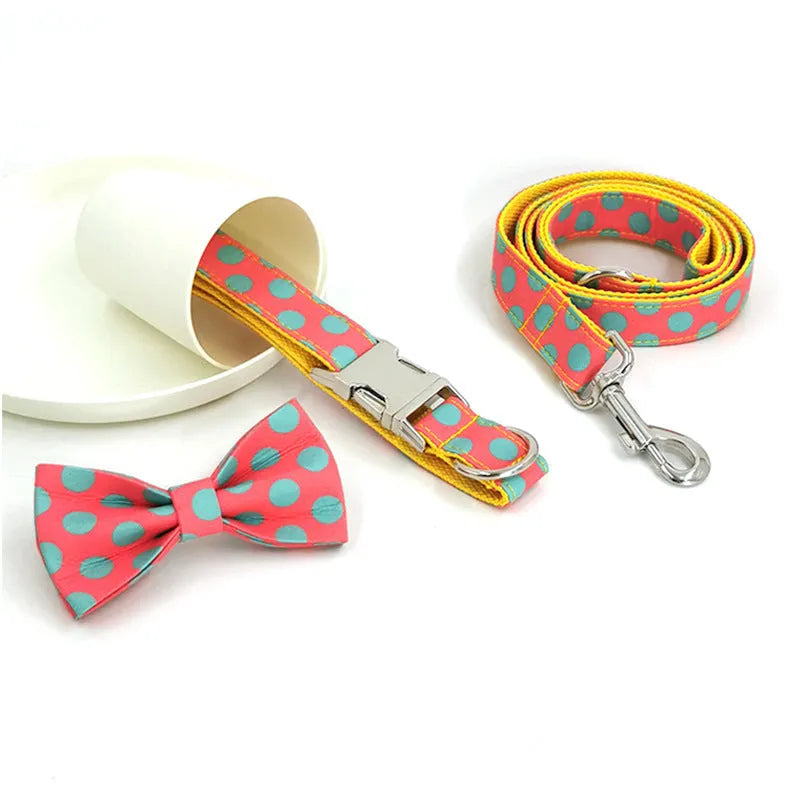 Yellow polka dot dog collar with bow and matching hand-held traction rope on white background