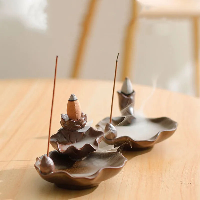 Square ceramic reverse flow incense burner with purple clay finish and lotus plum blossom decoration.