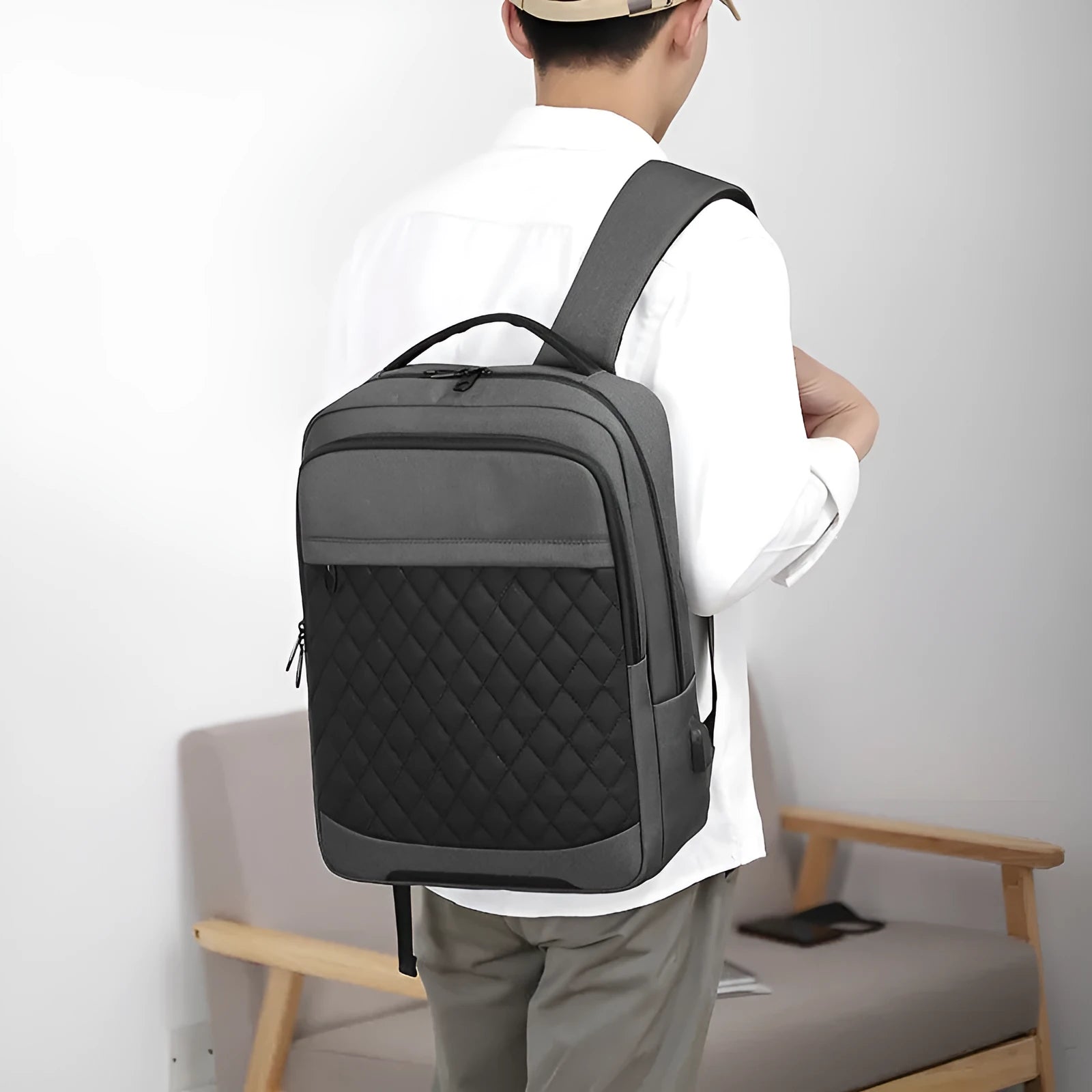 Men's leisure travel backpack in solid black Oxford cloth with curved shoulder straps and diamond mesh detailing