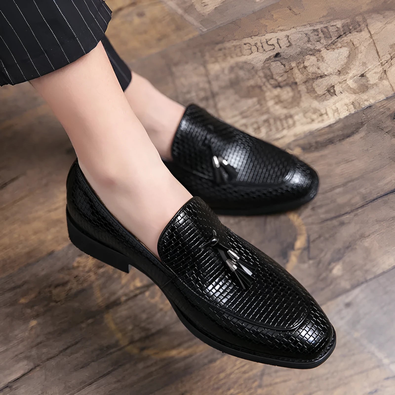 Men's black pointed slip-on shoes with tassel detail on artificial PU upper