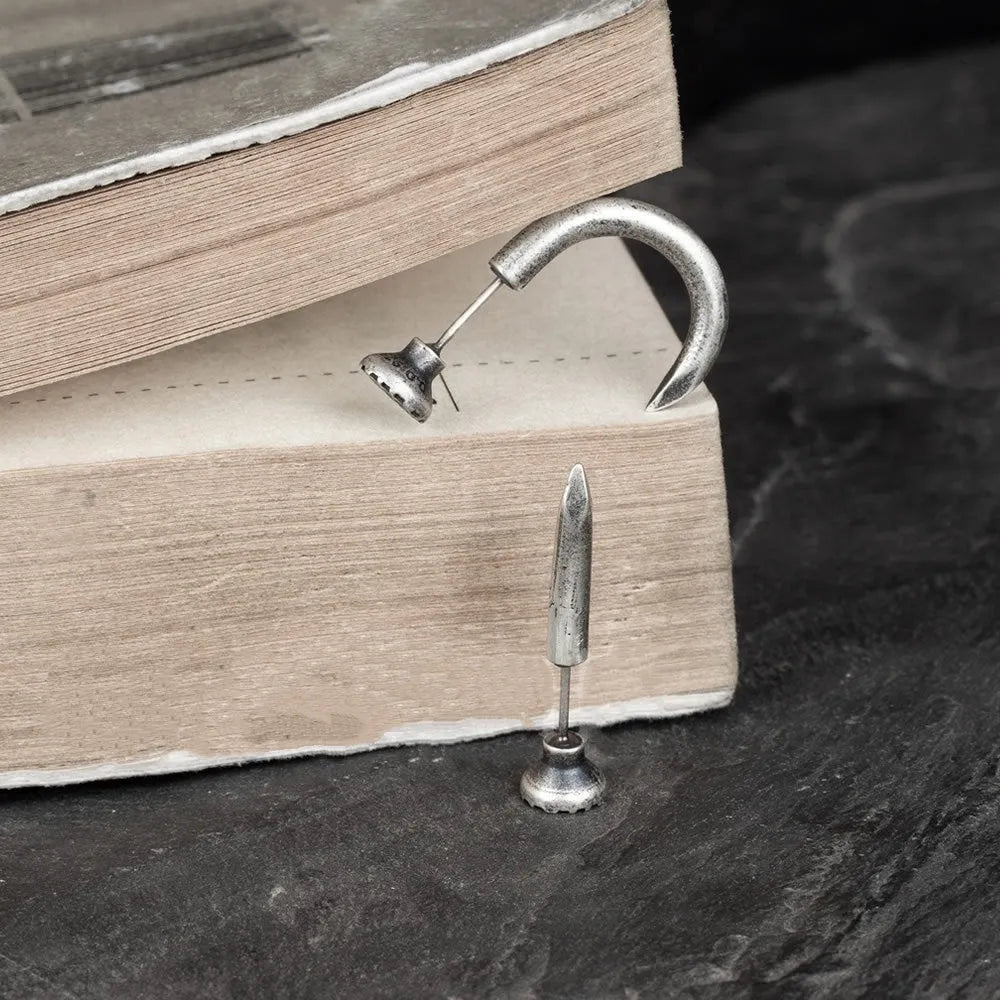 S925 sterling silver punk stud earring in straight nail or curved nail design on a hook.