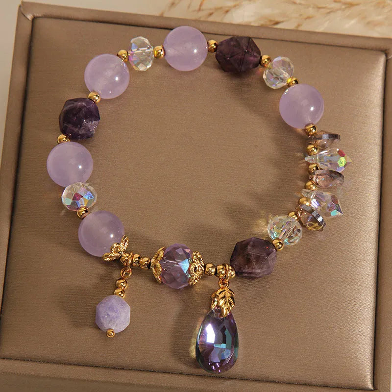 Children's crystal bracelet with lavender purple water-drop crystals on a plain background