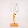 Rose gold plated portable touch control LED night light with acrylic shade on a table.