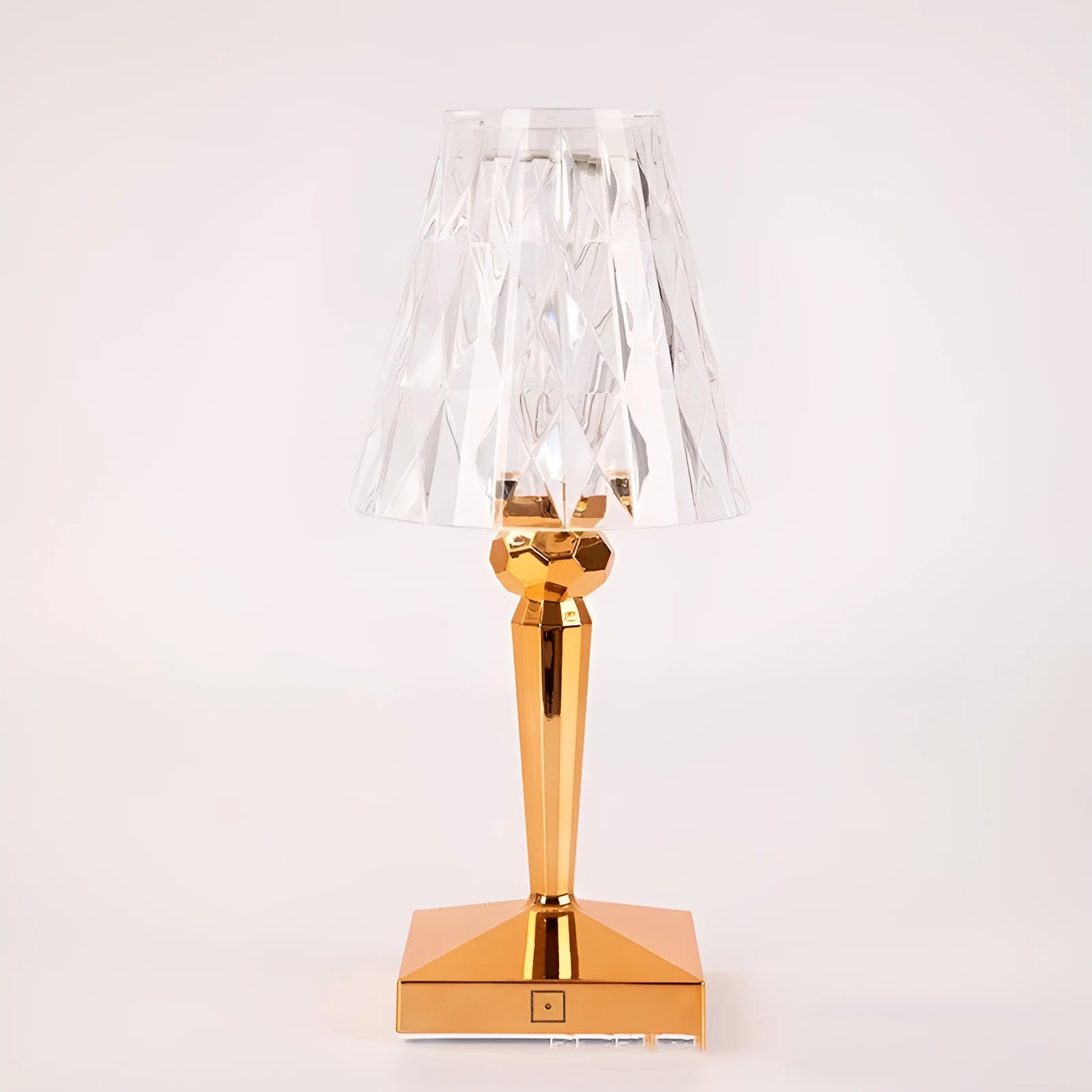 Rose gold plated portable touch control LED night light with acrylic shade on a table.