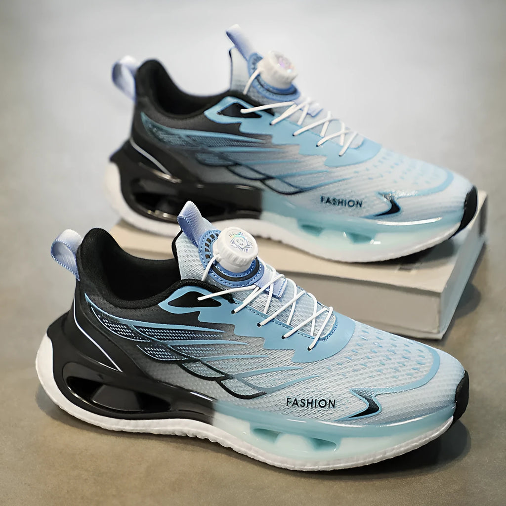Low-top youth sneaker with a rotating button closure on a rubber sole, shown in light blue mesh.