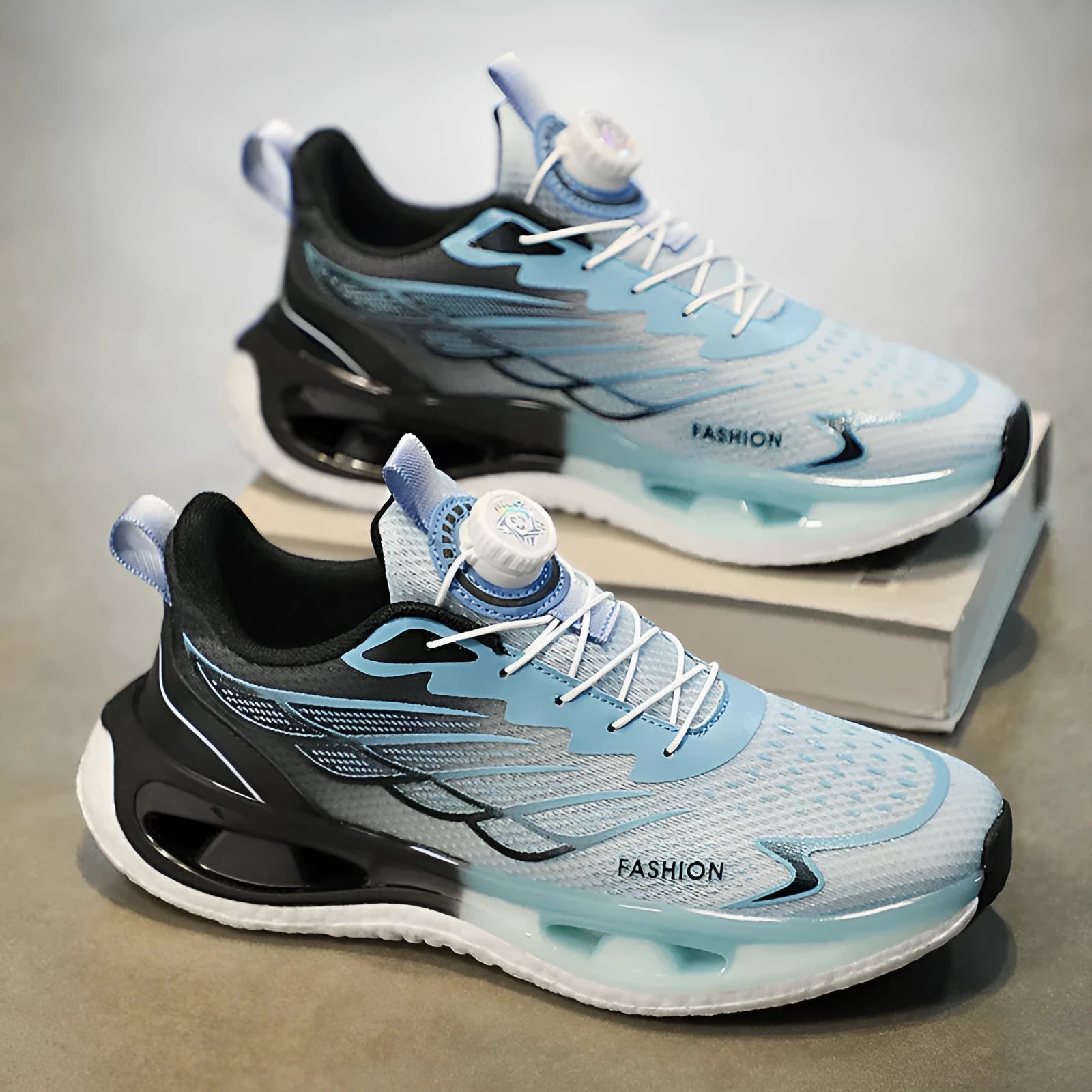 Low-top youth sneaker with a rotating button closure on a rubber sole, shown in light blue mesh.