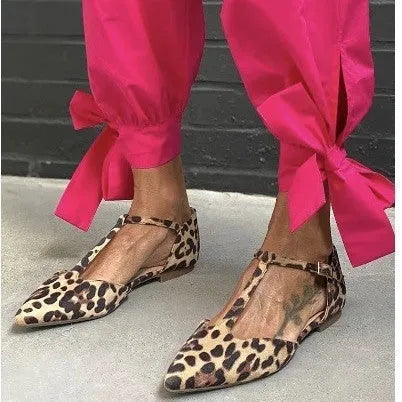 Women's leopard print pumps with pointed toe, chunky low heel, and cross shoulder straps