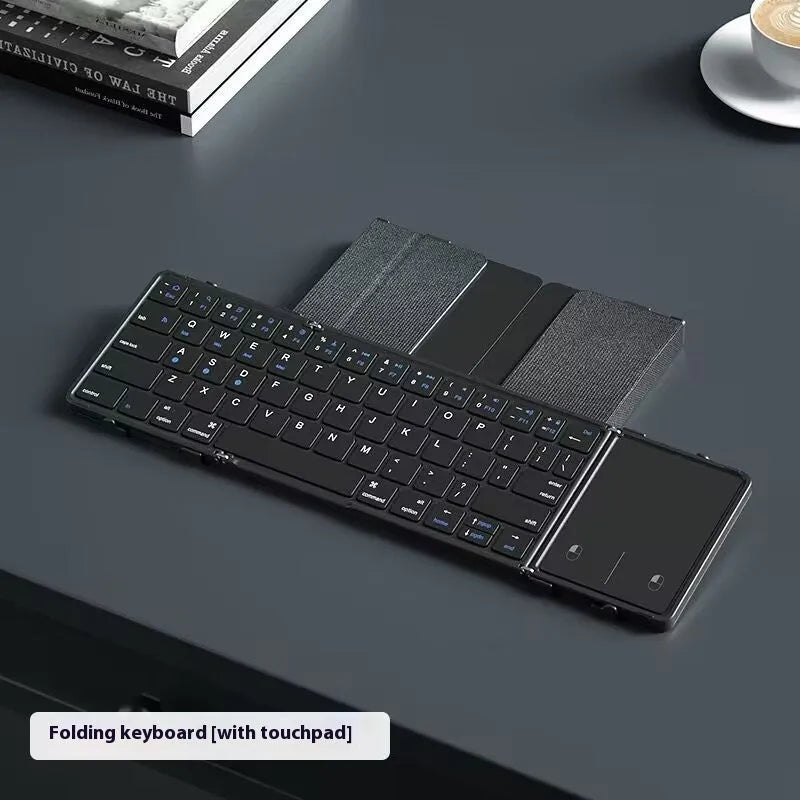 Black folding Bluetooth keyboard for mobile phones and tablets showing compact folded size