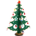 Set of three hand painted wooden Christmas trees in green on a table, largest 36cm tall