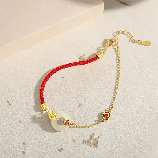 Gold 925 silver koi peace buckle bracelet with red rope on white background