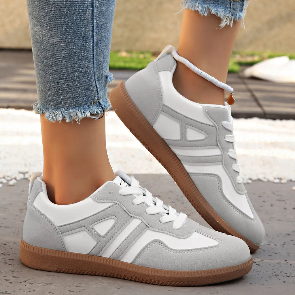Women's retro lace-up jogging shoes in grey with a colour-matched cross strap and platform sole.