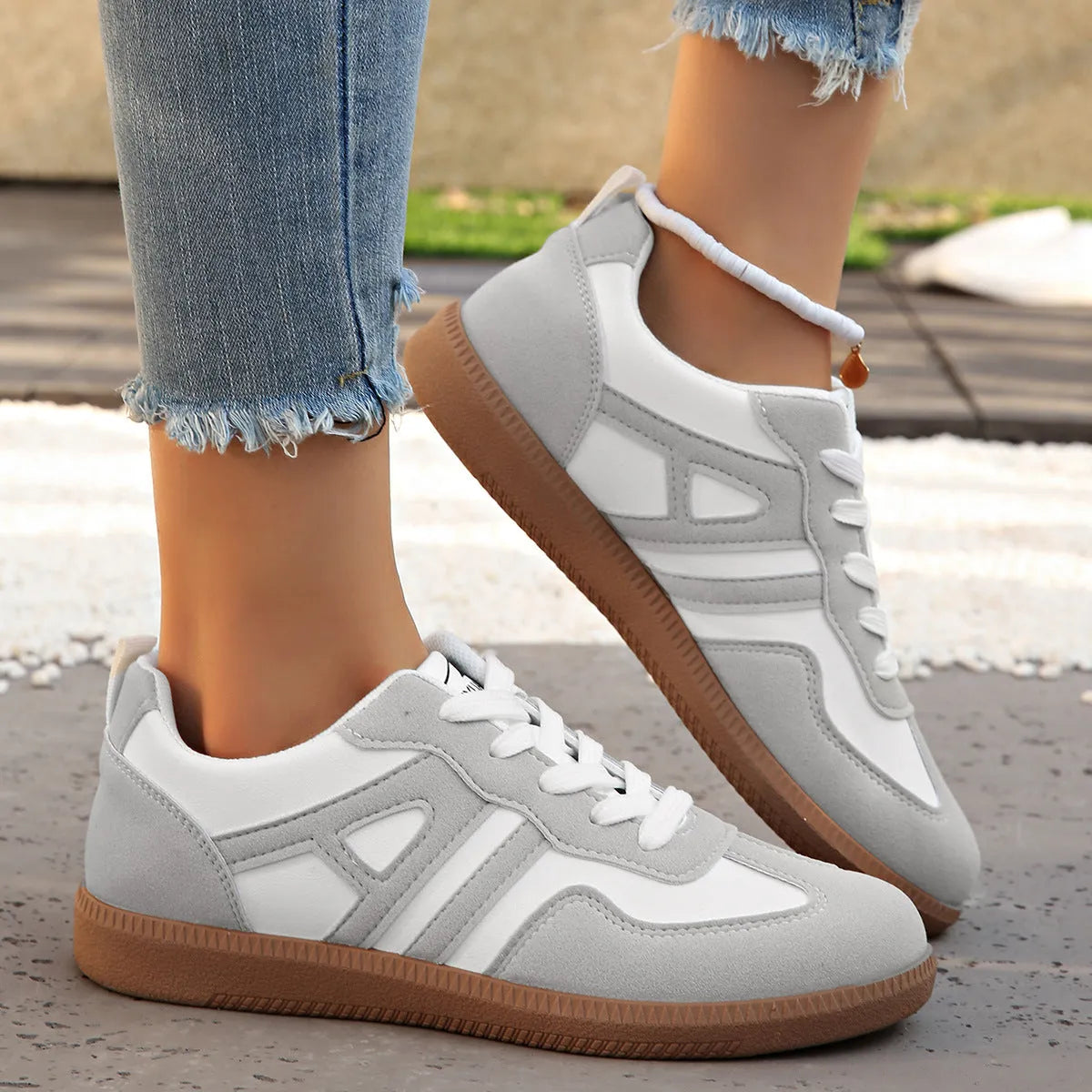 Women's retro lace-up jogging shoes in grey with a colour-matched cross strap and platform sole.