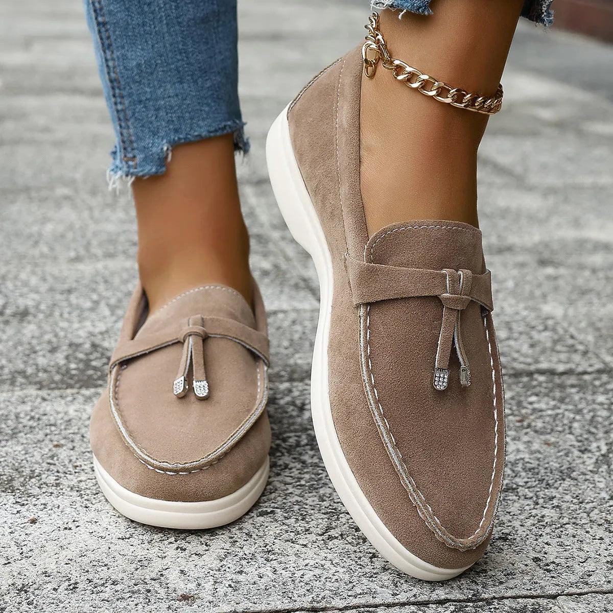 A pair of slip-on canvas loafers with a platform heel and round toe in a solid colour.