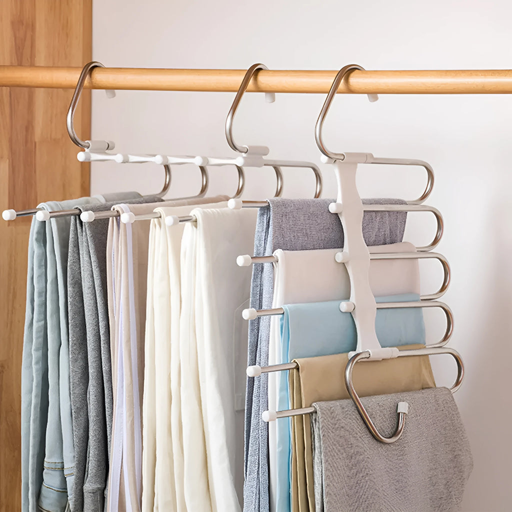 Black 5-in-1 stainless steel trouser hanger with five booms and dual hooks on a clothes rack