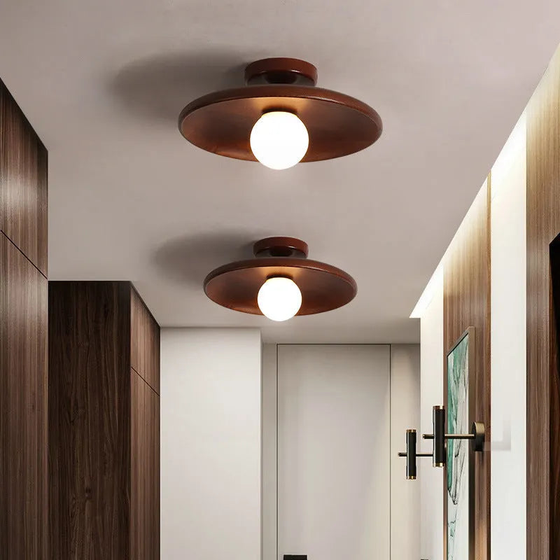 Modern solid wood ceiling lamp with glass shade in light wood and walnut colour finishes.