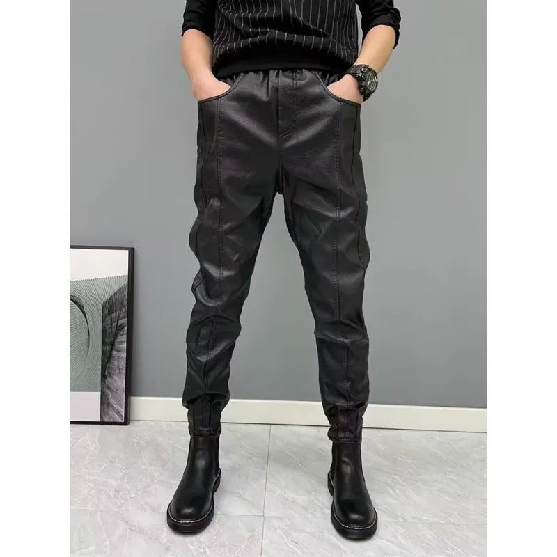 Black PU leather motorcycle takeaway pants with cuffs, tapered leg, and mid-rise waist, on a model