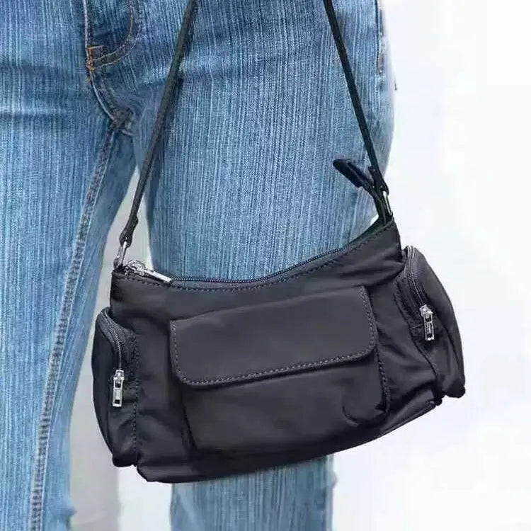Simple black lightweight women's PU shoulder bag with two front pockets and side line detail.