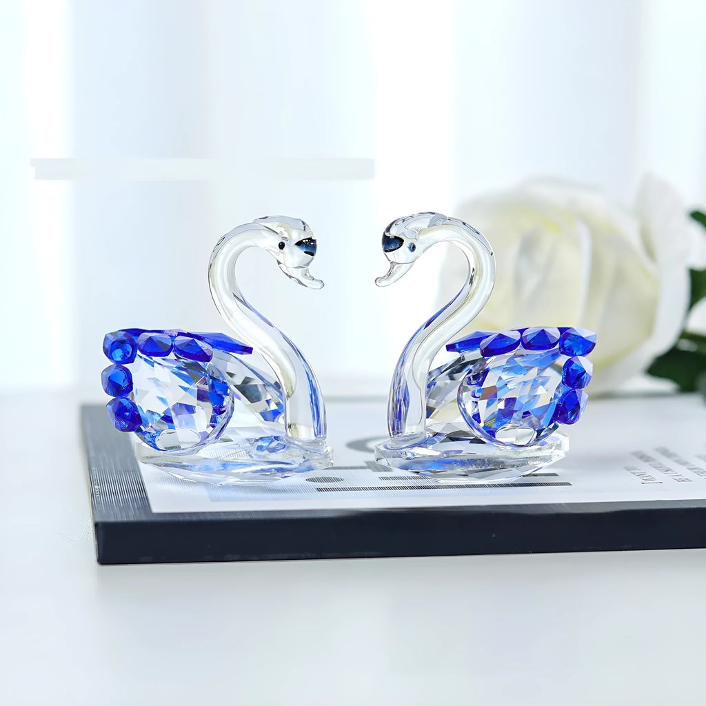 Clear crystal swan desktop ornament on a wooden surface