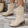 Milky white suede mid heel boots for women in plus sizes, showing leather stitching and a rubber sole.
