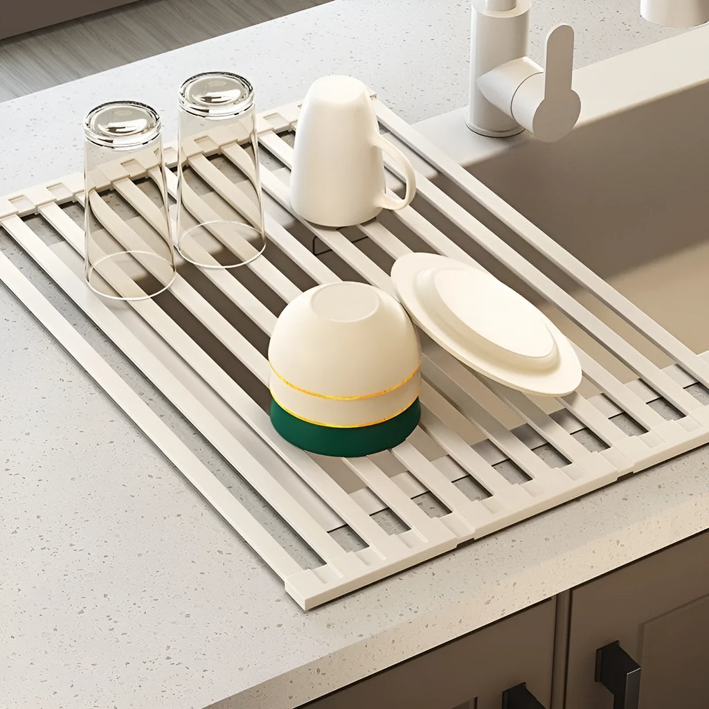 Milky white foldable stainless steel draining rack showing tri-fold design with dishes