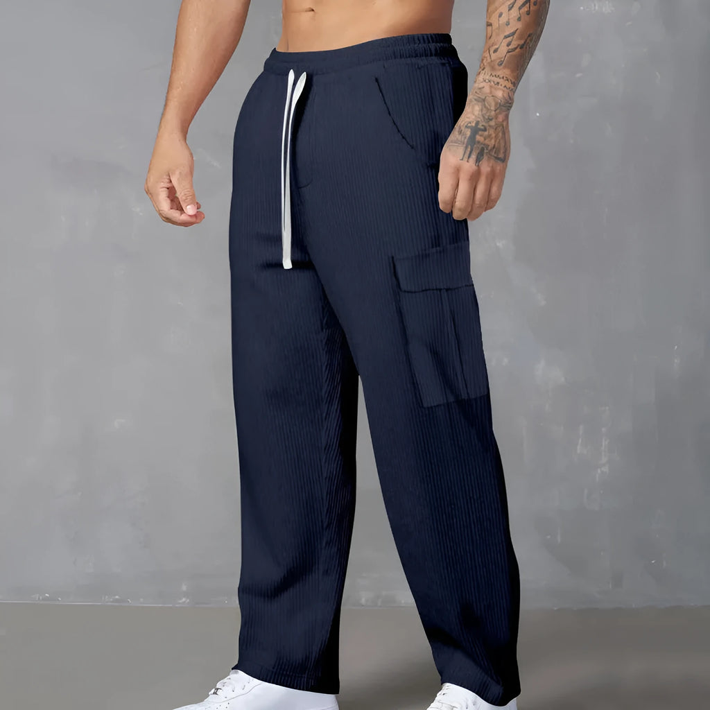 Men's loose-fitting corduroy cargo trousers in navy blue with a drawstring waist and wide straight legs