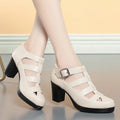 Women's beige closed toe sandals with woven upper, ankle strap, buckle, and back zipper on a chunky heel.