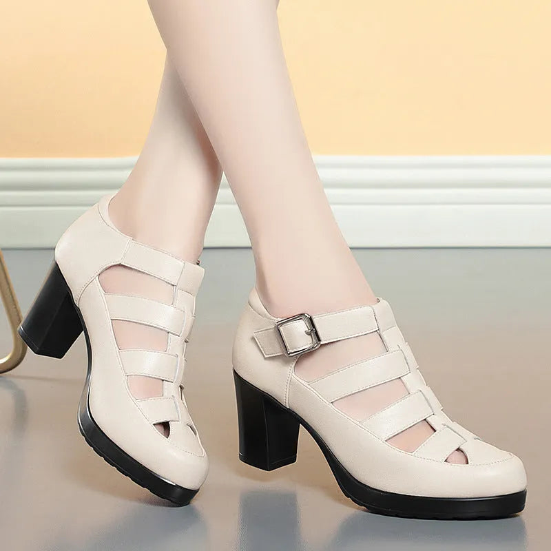 Women's beige closed toe sandals with woven upper, ankle strap, buckle, and back zipper on a chunky heel.
