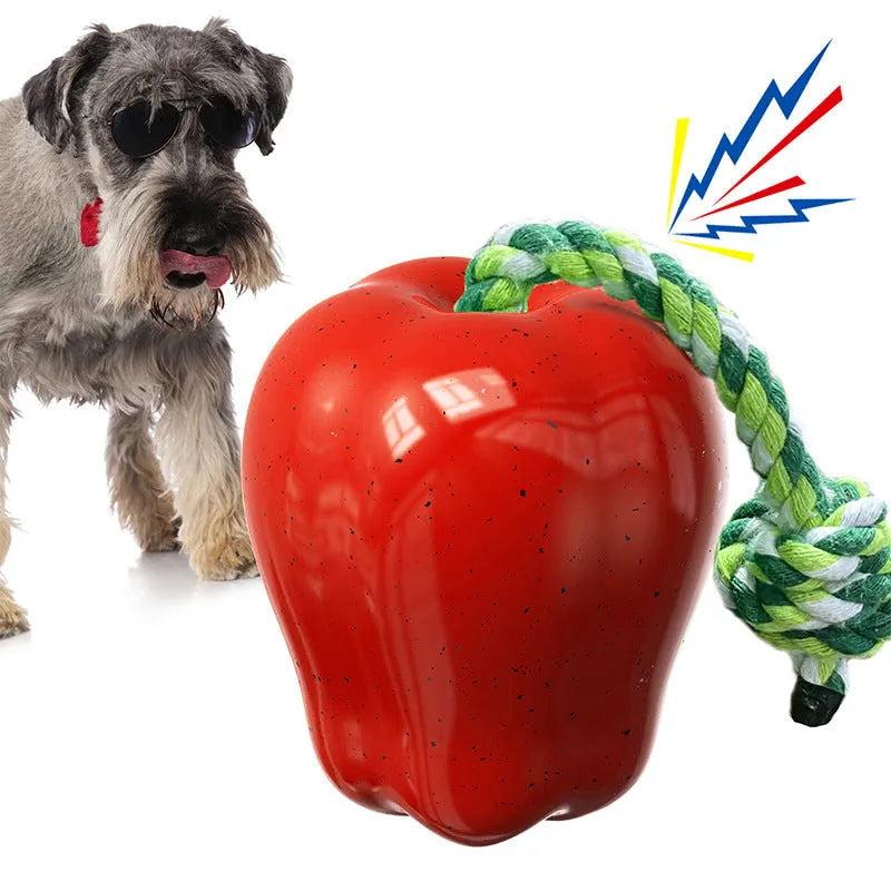 Green and red plastic apple-shaped dog toy with dropping ball for food dispensing