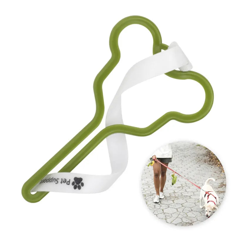 A hands-free dog poop bag holder with a fixed clip and adjustable hook and loop fastener attached to a dog leash.