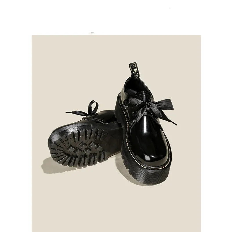 Women's black leather shoes with thick sole and cross-strap design