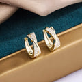 Geometric women's earrings with 14K yellow gold finish and zircon stone details on copper base
