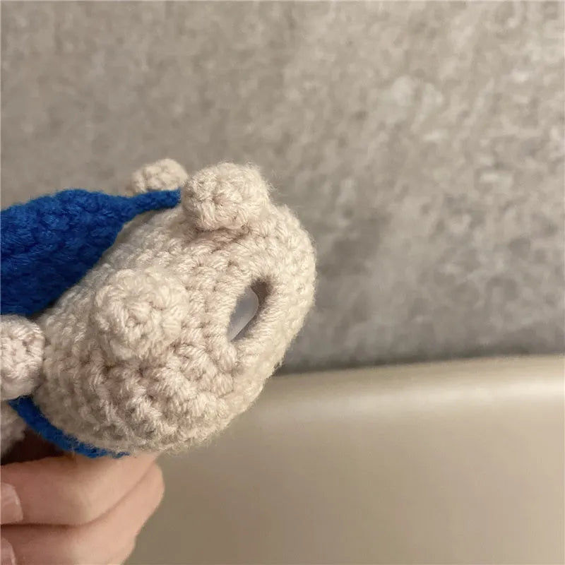 Hand-knitted koala bear backpack design cover for Apple AirPods charging case on a white background.