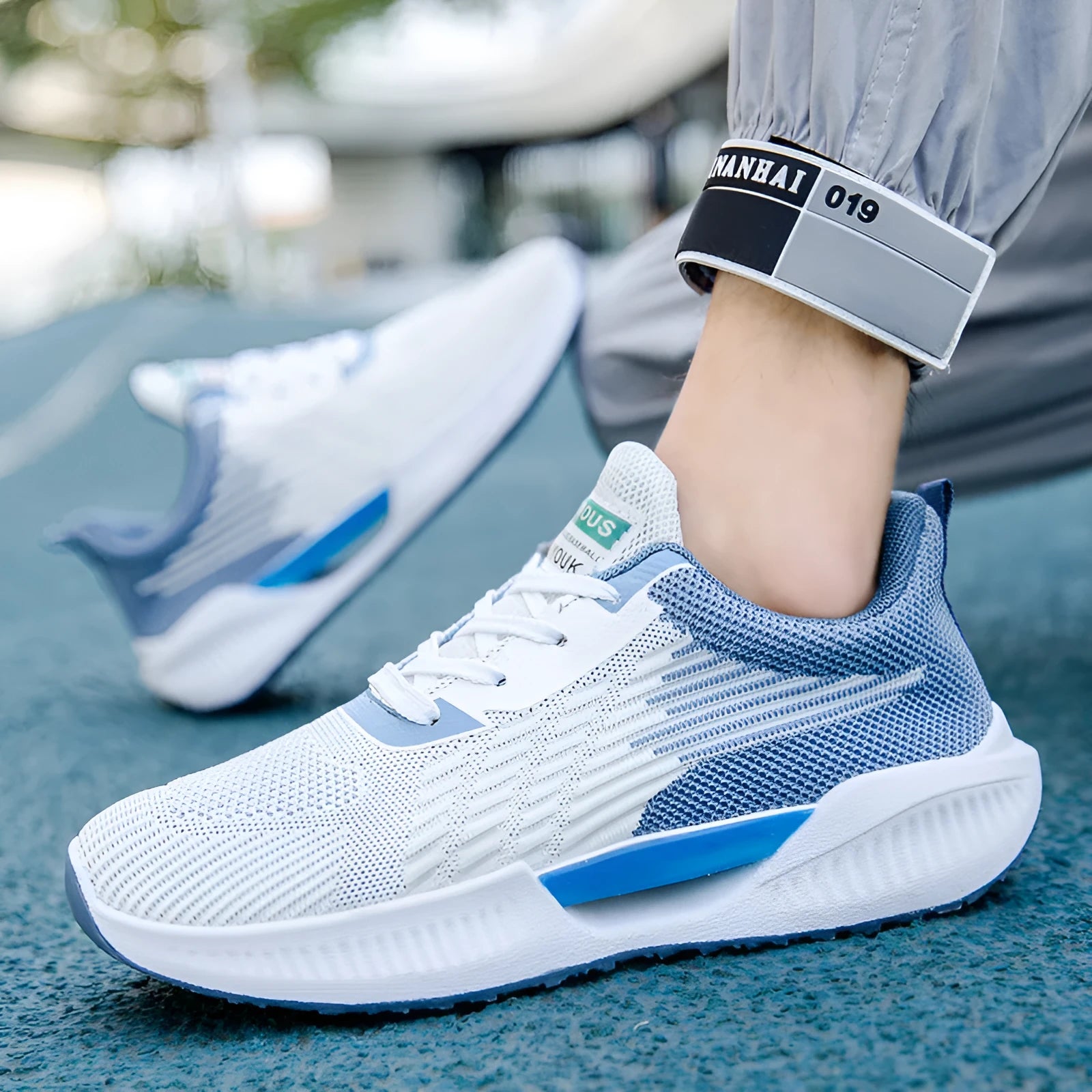 Men's blue casual mesh shoes with cloth upper and plastic sole on a white background.