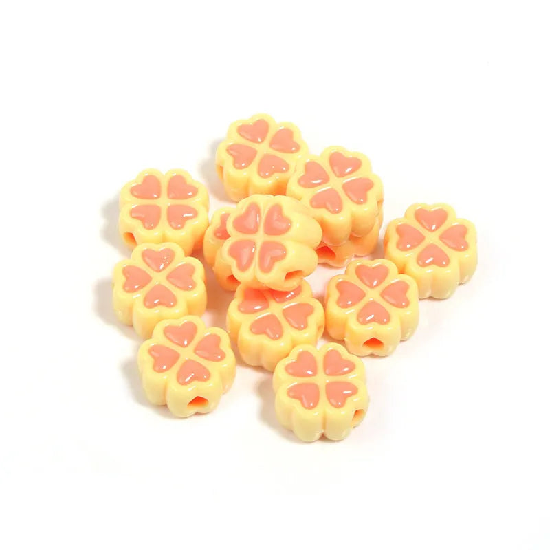 Acrylic four-leaf clover craft beads with love pattern in mixed colours showing frosted finish