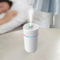 Black and white USB car humidifier with aromatherapy function on a car dashboard