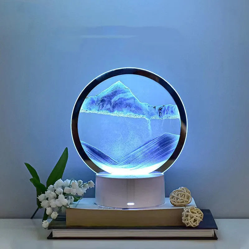 Creative 3D quicksand table lamp with glass shade on bedside table showing blue light colour