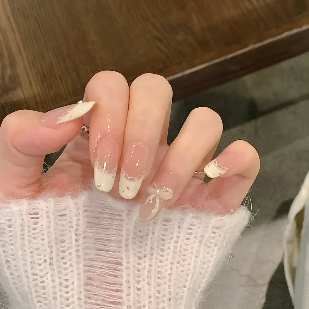 Set of short, colourful fake nails for girls with adhesive tabs on a pink background.