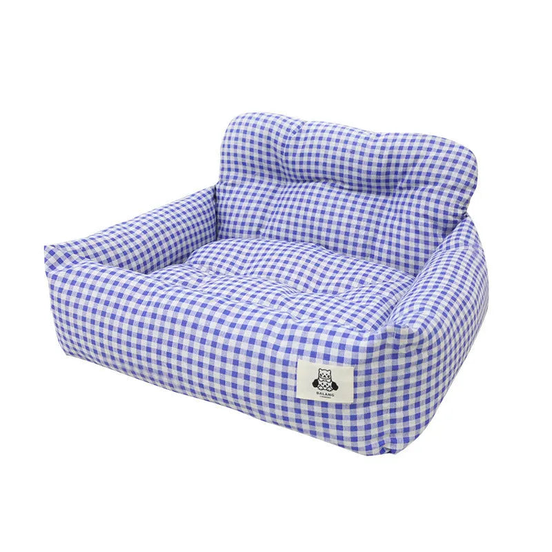 Grey and blue plaid car-mounted removable pet travel nest for dogs on a car seat