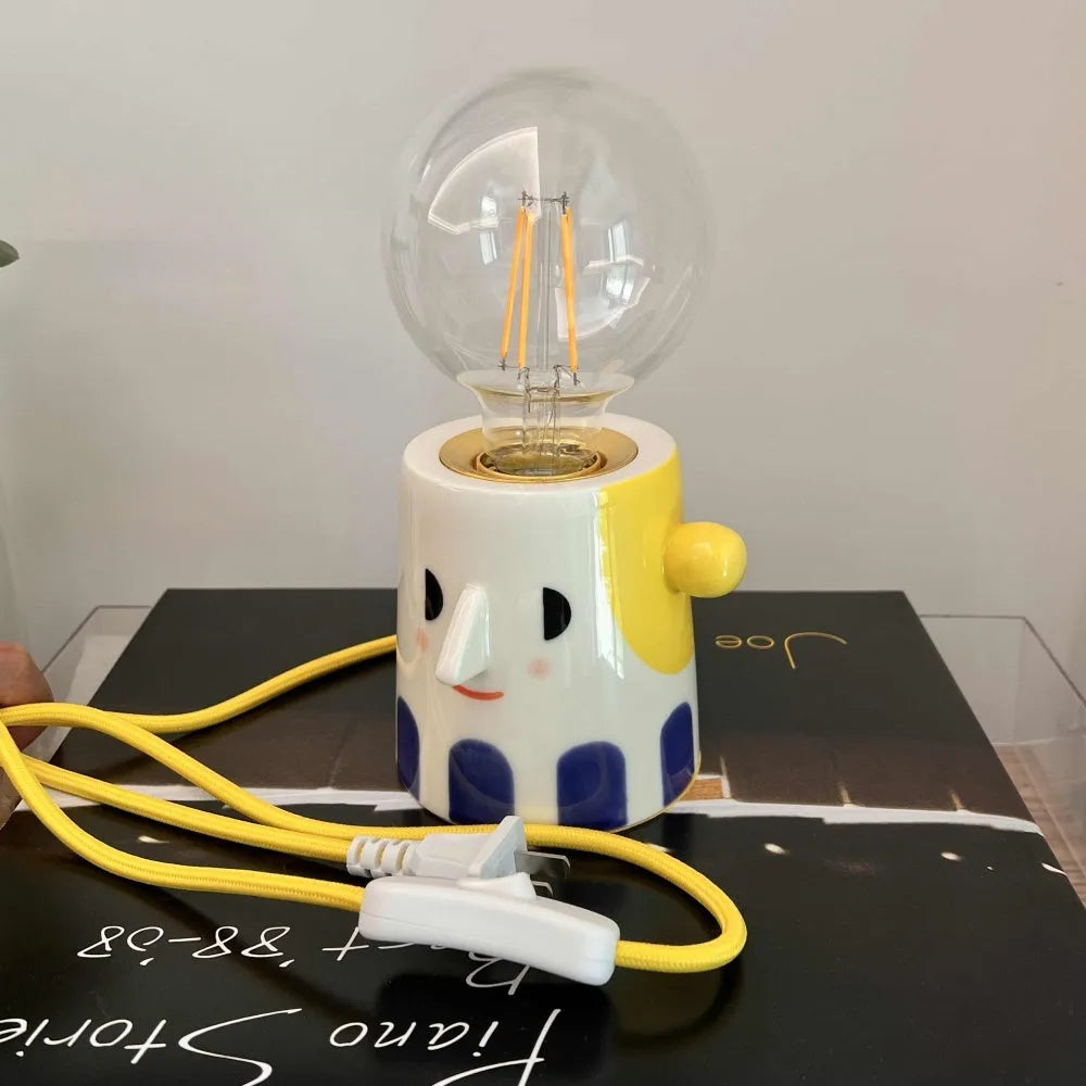 Handmade ceramic bedside lamp with ball headlight design in warm white colour