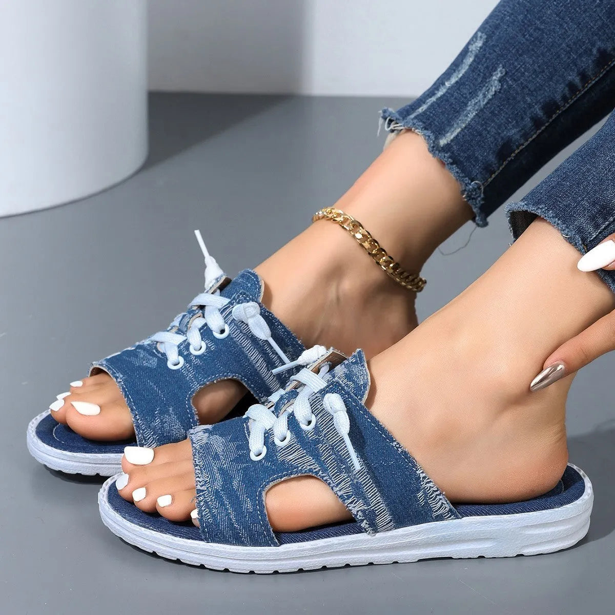 Blue women's canvas slippers in Roman style with a flat design and rubber sole