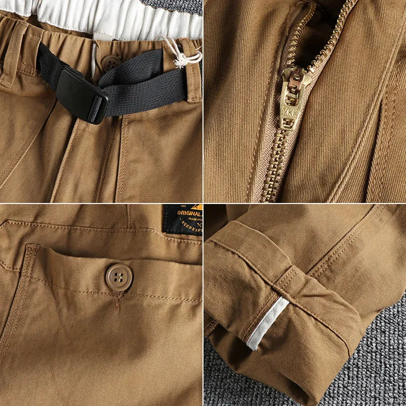 Men's khaki trousers with N buckle belt closure and zipper fly on a mid-waist fit.