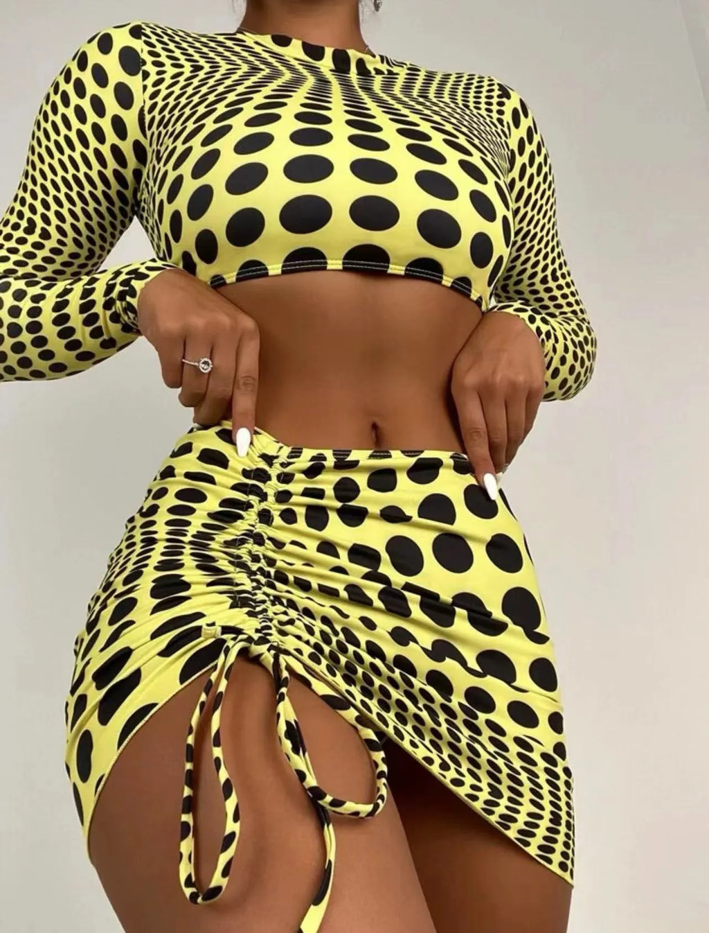 Women's green polka dot three-piece swimsuit set with top, skirt, and bra