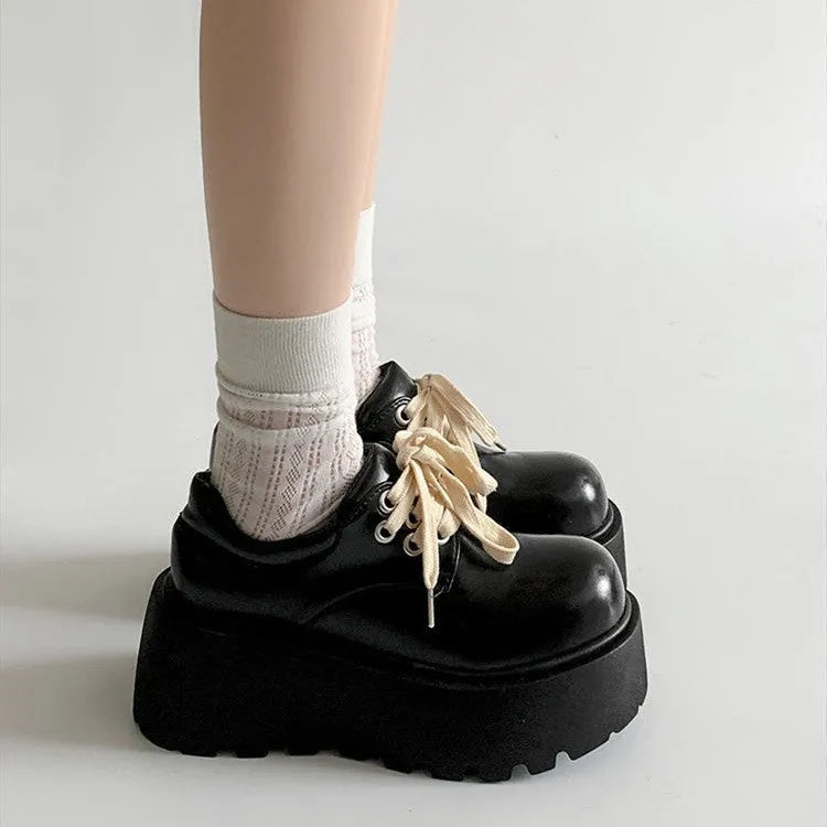 Matte black women's low-top shoes with a chunky 6-8cm heel and thick rubber sole on a white background.