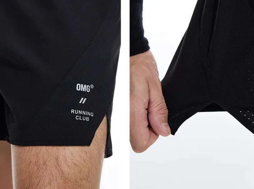 Black running shorts with laser stitching detail on a grey background.