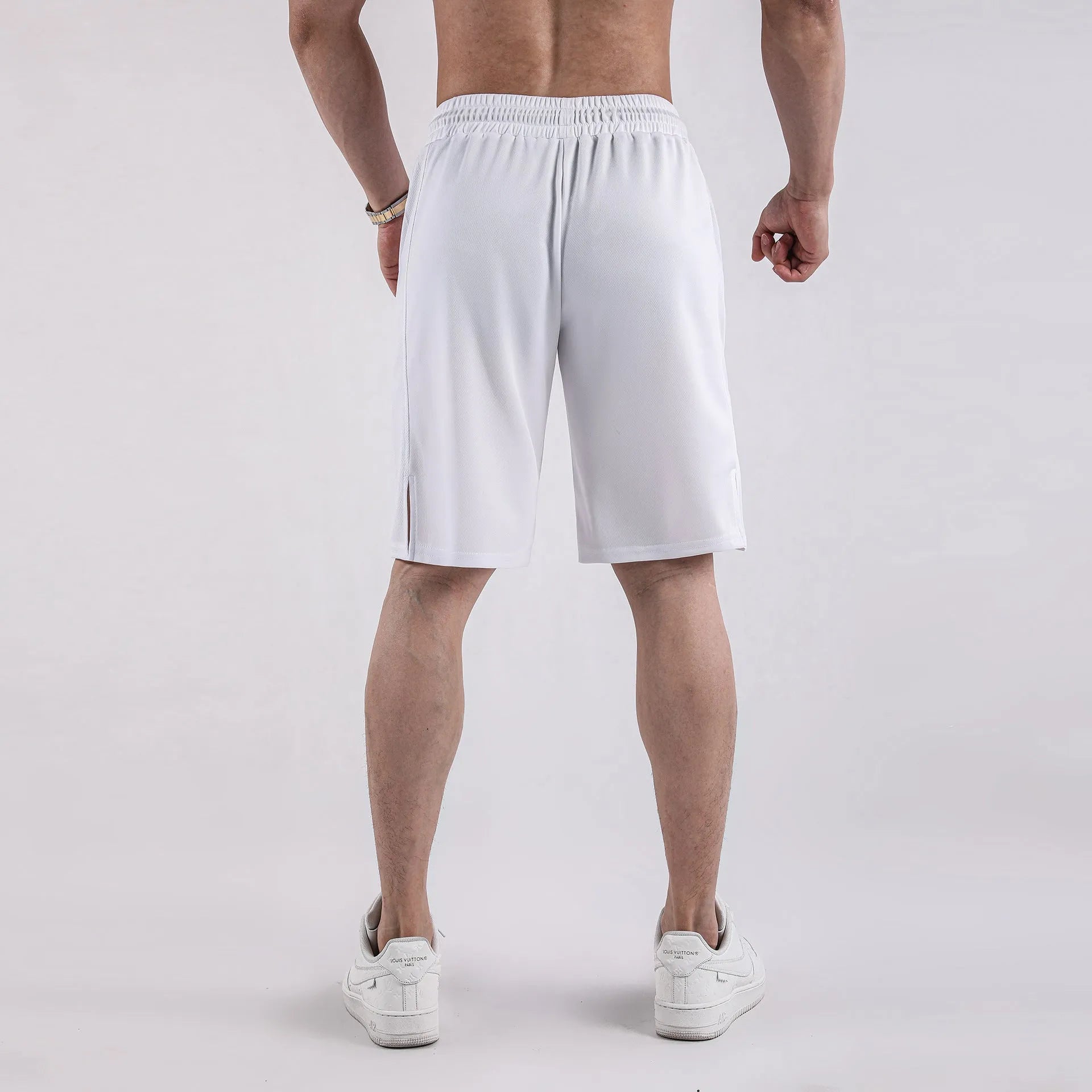 Men's black quick-dry mesh fitness shorts with elastic waistband laid flat.