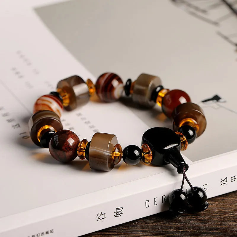 Natural twining line old agate bracelet with sardonyx agate abacus beads and white and red agate spacer beads on neutral background